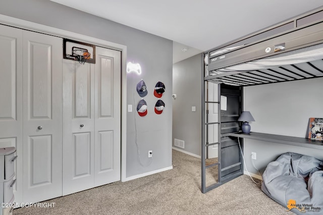 bedroom featuring carpet flooring, a closet, baseboards, and an office area