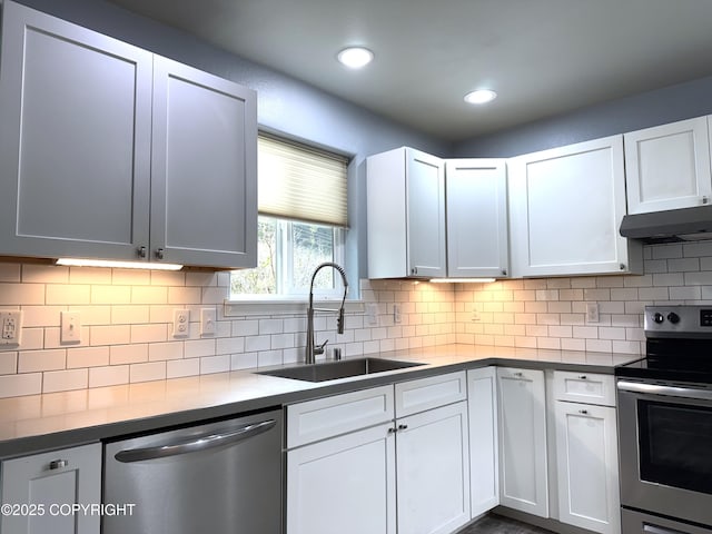 2321 Selief Ln, Kodiak, AK 99615 - kitchen featuring stainless steel appliances, a sink, under cabinet range hood, white cabinetry, and recessed lighting