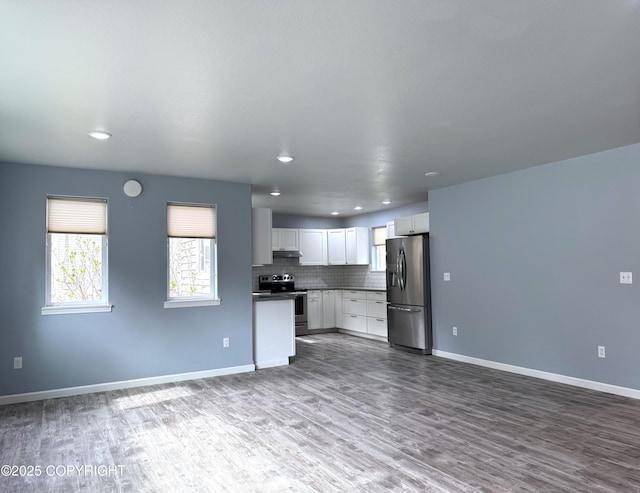 2321 Selief Ln, Kodiak, AK 99615 - kitchen featuring stainless steel appliances, open floor plan, dark wood-style floors, white cabinetry, and dark countertops