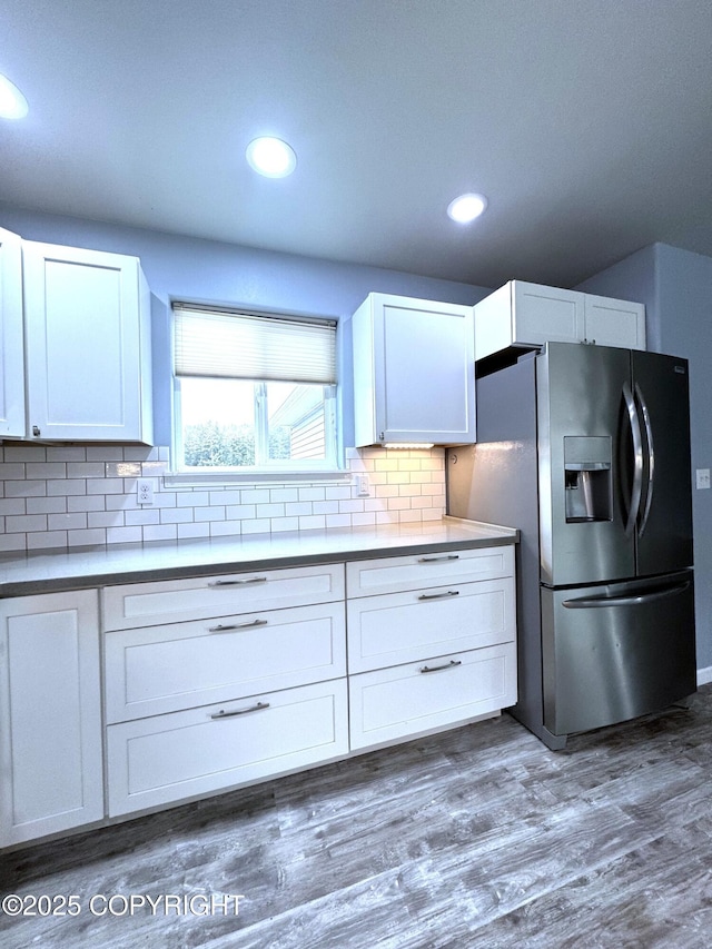 2321 Selief Ln, Kodiak, AK 99615 - kitchen featuring stainless steel fridge with ice dispenser, decorative backsplash, white cabinets, dark wood-type flooring, and recessed lighting
