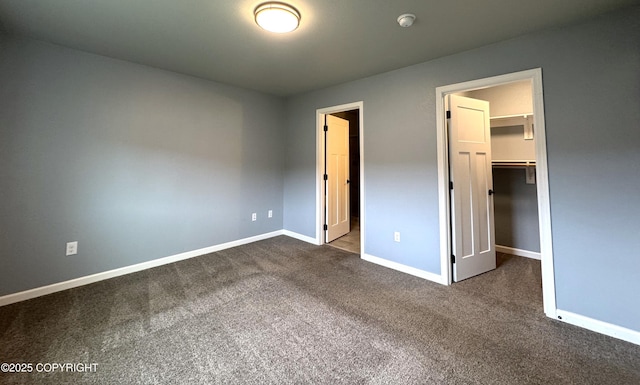 2321 Selief Ln, Kodiak, AK 99615 - unfurnished bedroom with a walk in closet, dark colored carpet, and baseboards