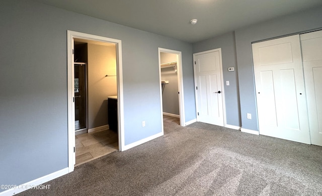 2321 Selief Ln, Kodiak, AK 99615 - unfurnished bedroom featuring carpet flooring, a closet, baseboards, and connected bathroom
