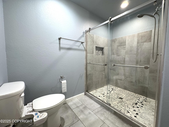 2321 Selief Ln, Kodiak, AK 99615 - bathroom with toilet, a shower stall, tile patterned floors, and baseboards