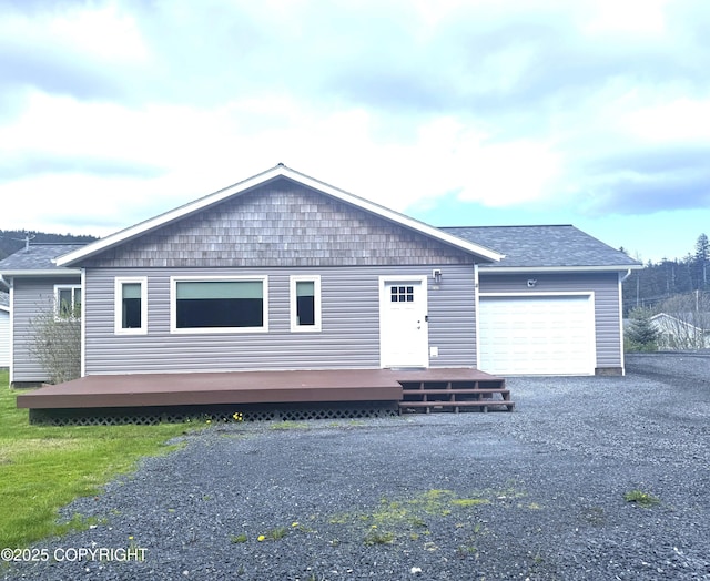 2321 Selief Ln, Kodiak, AK 99615 - view of front facade with a garage, a wooden deck, and a shingled roof