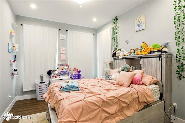 bedroom featuring wood finished floors, baseboards, and recessed lighting