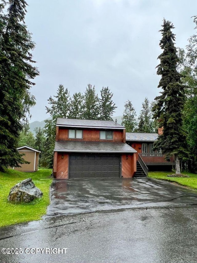 garage with asphalt driveway