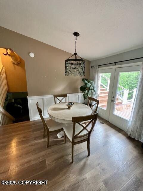 dining area with french doors and wood finished floors