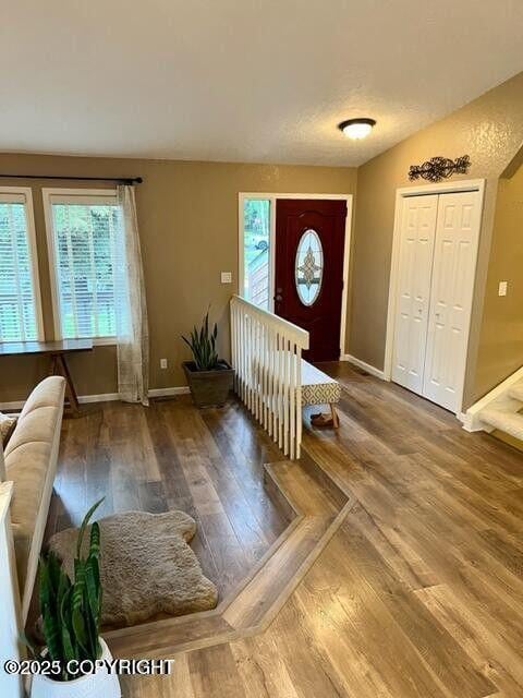 foyer with wood finished floors and baseboards