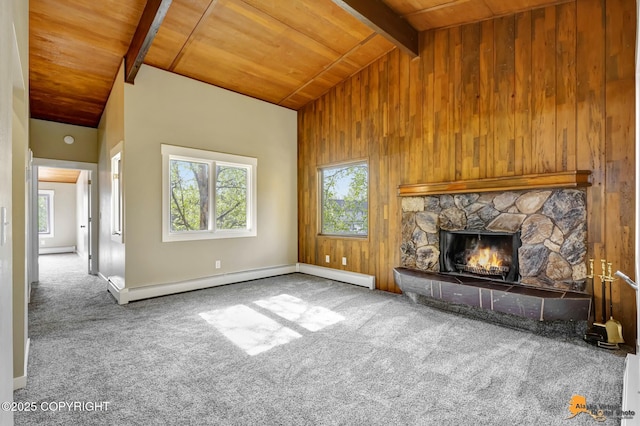 unfurnished living room featuring wooden ceiling, healthy amount of natural light, wooden walls, carpet, and a stone fireplace