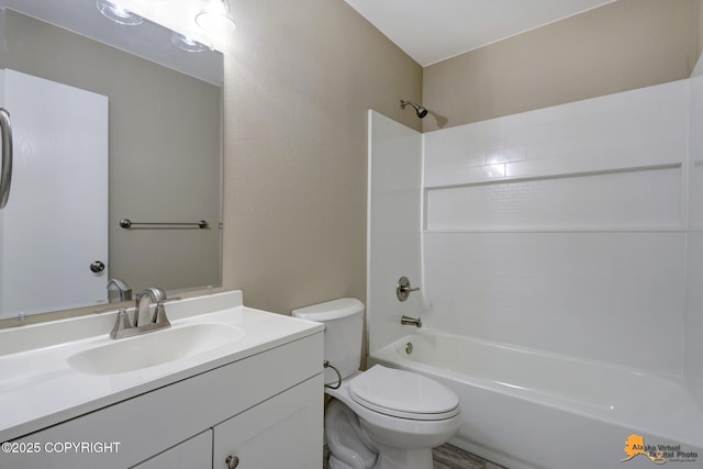 bathroom featuring toilet, vanity, and shower / bath combination
