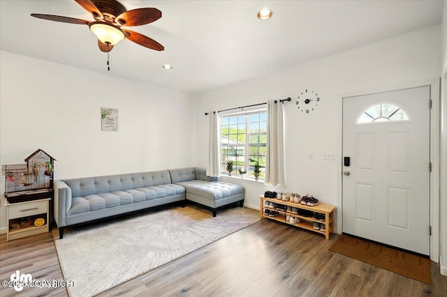 6744 Bogle Bluff Dr, Wasilla, AK 99623 - living area with plenty of natural light, wood finished floors, a ceiling fan, and recessed lighting