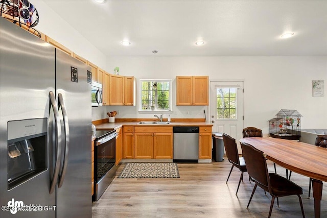 6744 Bogle Bluff Dr, Wasilla, AK 99623 - kitchen featuring stainless steel appliances, a sink, light wood-type flooring, recessed lighting, and light countertops