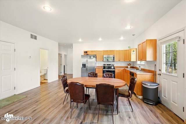 6744 Bogle Bluff Dr, Wasilla, AK 99623 - dining space with light wood-type flooring, recessed lighting, and baseboards