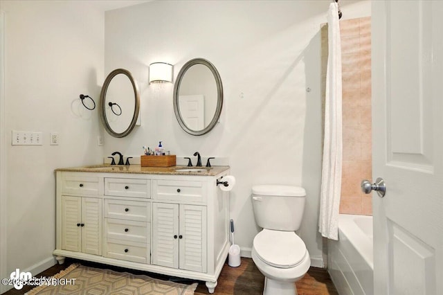 6744 Bogle Bluff Dr, Wasilla, AK 99623 - bathroom featuring baseboards, toilet, wood finished floors, double vanity, and shower / bath combination with curtain