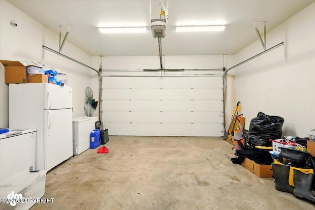 6744 Bogle Bluff Dr, Wasilla, AK 99623 - garage featuring freestanding refrigerator, a garage door opener, and fridge
