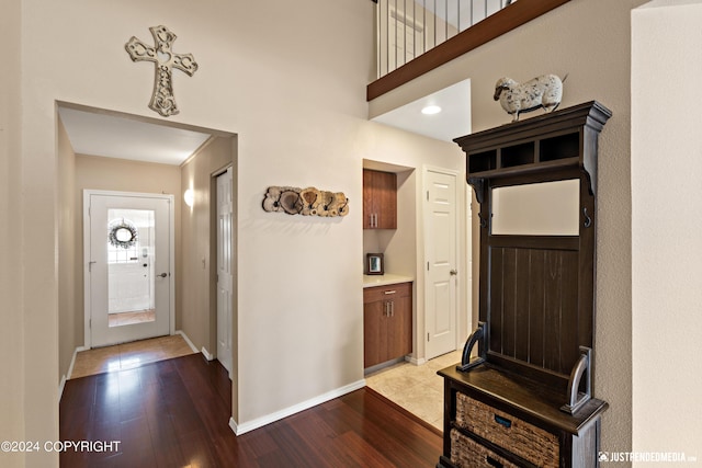 foyer with wood finished floors and baseboards
