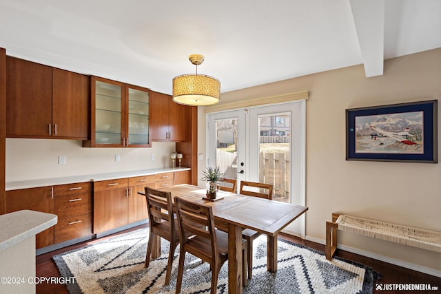 dining area featuring dark wood-style flooring, french doors, and baseboards