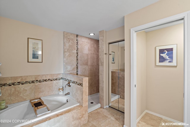 full bath with a stall shower, a garden tub, and tile patterned flooring