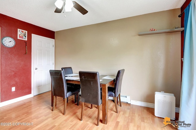 2816 Leighton St, Anchorage, AK 99517 - dining room with light wood-style flooring, a ceiling fan, and baseboard heating