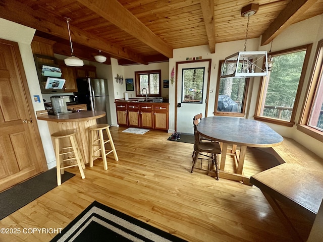 1581 Jade Dr, Homer, AK 99603 - dining space featuring light wood-style flooring, wooden ceiling with exposed beams, and baseboards