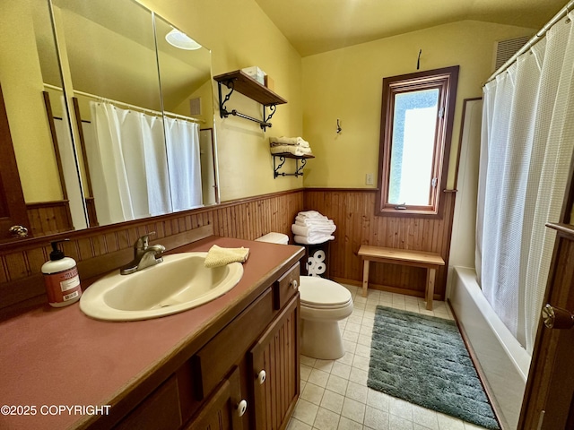 1581 Jade Dr, Homer, AK 99603 - bathroom with wainscoting, toilet, vanity, tile patterned floors, and shower / tub combo