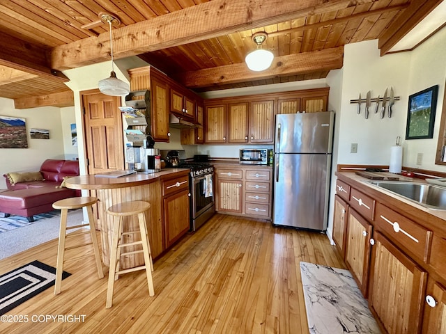 1581 Jade Dr, Homer, AK 99603 - kitchen with appliances with stainless steel finishes, wooden ceiling with exposed beams, under cabinet range hood, light wood-style floors, and brown cabinets