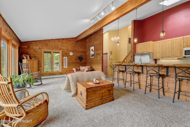 26266 Vallihi Cir, Eagle River, AK 99577 - carpeted living room featuring lofted ceiling, wooden walls, a baseboard radiator, and a chandelier