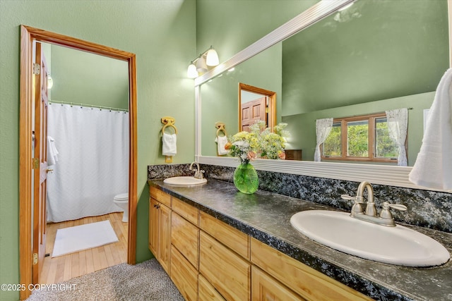 26266 Vallihi Cir, Eagle River, AK 99577 - full bath with toilet, double vanity, a shower with shower curtain, and wood finished floors