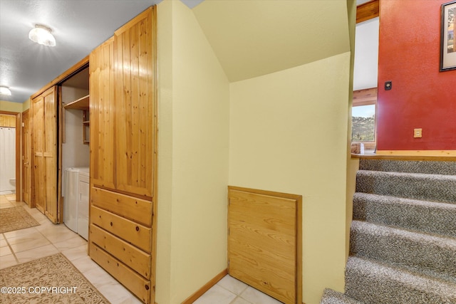 26266 Vallihi Cir, Eagle River, AK 99577 - staircase featuring washer and dryer and tile patterned floors