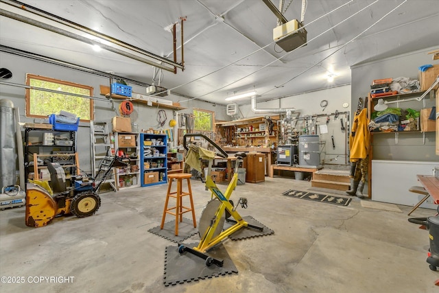 26266 Vallihi Cir, Eagle River, AK 99577 - garage featuring a garage door opener and a workshop area