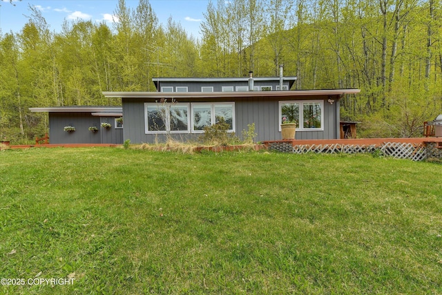 26266 Vallihi Cir, Eagle River, AK 99577 - back of house with a forest view and a lawn