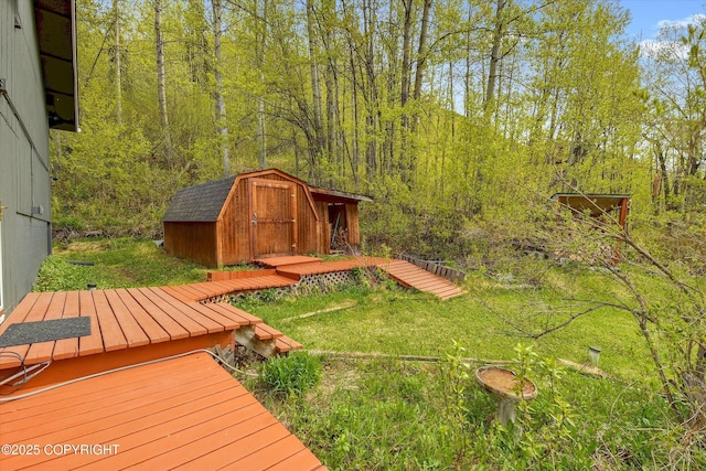 26266 Vallihi Cir, Eagle River, AK 99577 - view of yard with a shed, an outdoor structure, and a view of trees