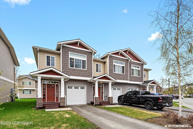 1473 Shallow Pool Dr # J1, Anchorage, AK 99504 - view of front of property with stone siding, driveway, an attached garage, and a front lawn