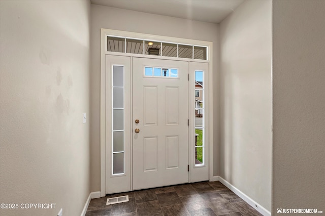 1473 Shallow Pool Dr # J1, Anchorage, AK 99504 - foyer with baseboards, healthy amount of natural light, and stone finish floors