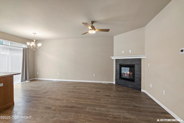 1473 Shallow Pool Dr # J1, Anchorage, AK 99504 - unfurnished living room with a ceiling fan, a chandelier, dark wood-style flooring, a fireplace, and baseboards