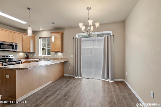 1473 Shallow Pool Dr # J1, Anchorage, AK 99504 - kitchen with appliances with stainless steel finishes, light brown cabinets, dark wood-type flooring, and a peninsula