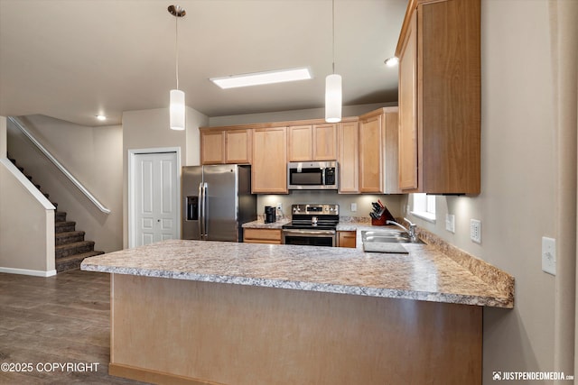 1473 Shallow Pool Dr # J1, Anchorage, AK 99504 - kitchen with appliances with stainless steel finishes, a peninsula, a sink, light countertops, and dark wood-style floors