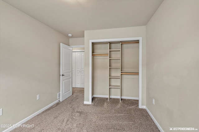 1473 Shallow Pool Dr # J1, Anchorage, AK 99504 - unfurnished bedroom with carpet floors, baseboards, and a closet