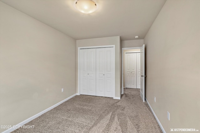 1473 Shallow Pool Dr # J1, Anchorage, AK 99504 - unfurnished bedroom with carpet, baseboards, and a closet