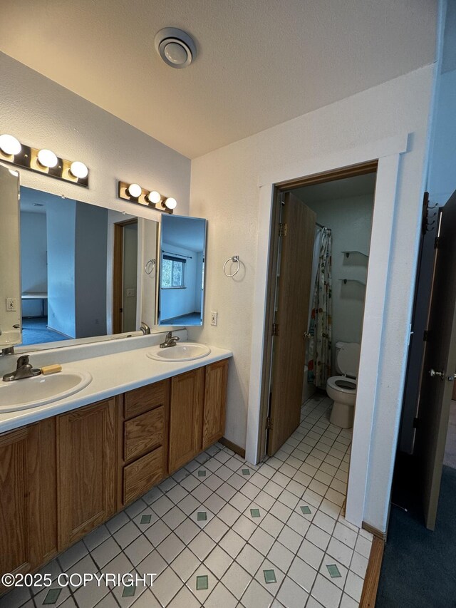 33325 Vinewood Ln, Seward, AK 99664 - bathroom featuring double vanity, toilet, a shower with shower curtain, and tile patterned flooring