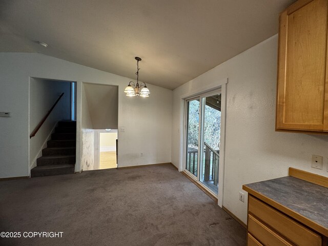 33325 Vinewood Ln, Seward, AK 99664 - unfurnished dining area with lofted ceiling, stairs, carpet, and a chandelier