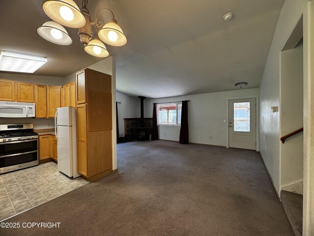 33325 Vinewood Ln, Seward, AK 99664 - kitchen with white appliances, a wood stove, light carpet, and open floor plan
