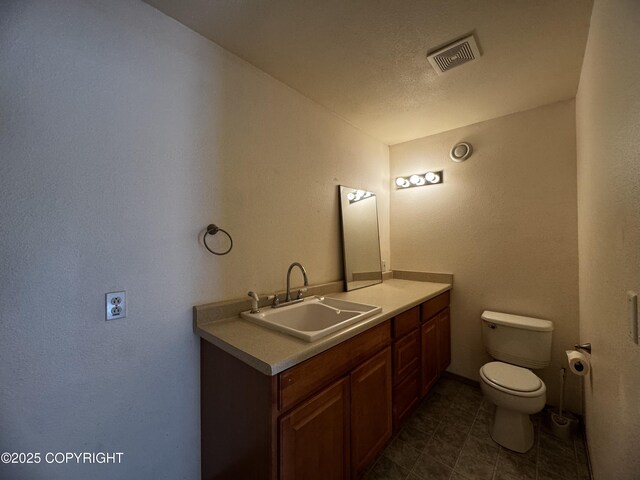 33325 Vinewood Ln, Seward, AK 99664 - bathroom featuring toilet, vanity, and tile patterned floors