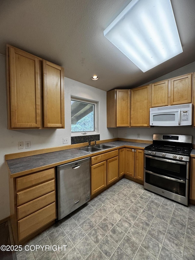 33325 Vinewood Ln, Seward, AK 99664 - kitchen with stainless steel appliances, a sink, a textured ceiling, dark countertops, and recessed lighting
