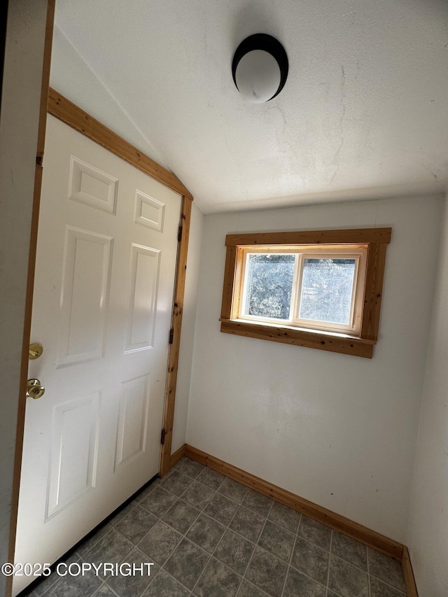 33325 Vinewood Ln, Seward, AK 99664 - entryway featuring baseboards and vaulted ceiling