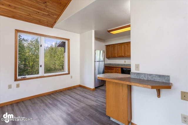 14184 W Jojoba Rd, Big Lake, AK 99623 - kitchen featuring freestanding refrigerator, brown cabinets, dark wood-style floors, a kitchen breakfast bar, and a peninsula