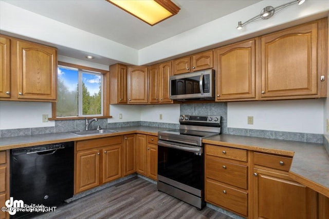 14184 W Jojoba Rd, Big Lake, AK 99623 - kitchen with stainless steel appliances, a sink, dark wood finished floors, brown cabinets, and backsplash