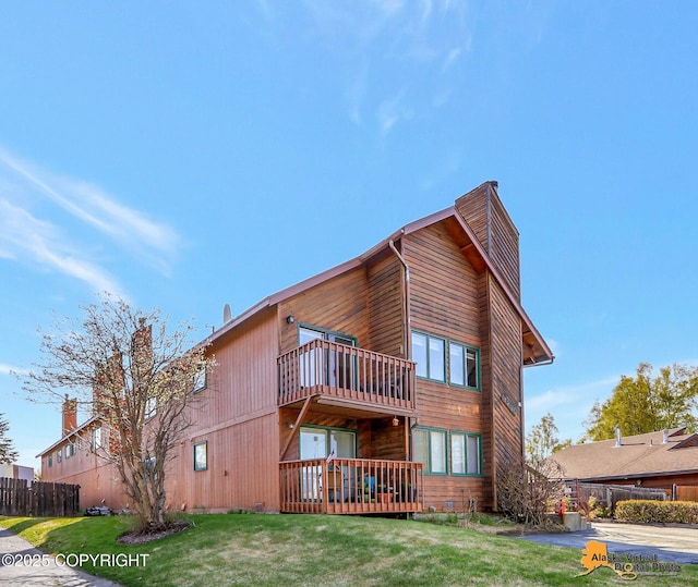4230 Woronzof Dr # D, Anchorage, AK 99517 - rear view of property featuring a balcony and a chimney