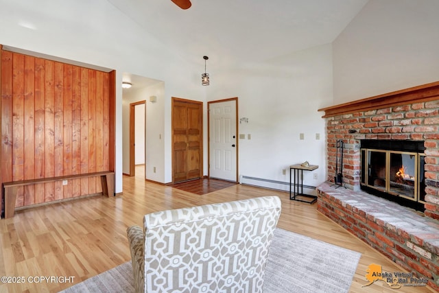 4230 Woronzof Dr # D, Anchorage, AK 99517 - living room with baseboard heating, wood finished floors, a fireplace, high vaulted ceiling, and ceiling fan