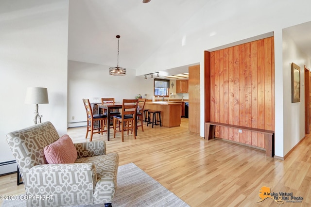 4230 Woronzof Dr # D, Anchorage, AK 99517 - living area with light wood-style flooring, a baseboard radiator, baseboard heating, and high vaulted ceiling